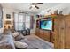 Cozy living room with media center, ceiling fan and comfortable seating at 3378 Sagebrush St, Harmony, FL 34773
