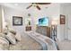 Inviting main bedroom is bright and airy with ensuite access, a ceiling fan and modern decor at 3378 Sagebrush St, Harmony, FL 34773