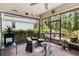 Enclosed patio with brick flooring, comfortable seating, and views of the landscaped yard at 3378 Sagebrush St, Harmony, FL 34773