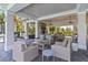 Inviting covered patio with comfortable seating, fireplace, and serene views, perfect for relaxing and entertaining at 3378 Sagebrush St, Harmony, FL 34773