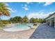 Expansive community pool with a beach entry, plenty of seating, and beautiful palm trees at 3378 Sagebrush St, Harmony, FL 34773