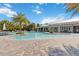 Spacious community pool with curved edges, a large pool deck and various seating arrangements at 3378 Sagebrush St, Harmony, FL 34773