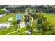 Aerial view of a well-maintained park featuring a basketball court, volleyball court, playground, and walking paths at 3425 Middlebrook Pl, Harmony, FL 34773