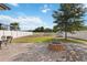Spacious backyard featuring a brick patio, green lawn, white fence, and mature tree at 3425 Middlebrook Pl, Harmony, FL 34773