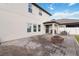 Back exterior view of a neutral two-story home with a brick patio and fire pit at 3425 Middlebrook Pl, Harmony, FL 34773