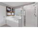 Bright bathroom features a bathtub, a separate shower, and white tiling at 3425 Middlebrook Pl, Harmony, FL 34773