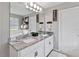 Bathroom with granite countertop, and sinks, walk-in closet, and a separate tub at 3425 Middlebrook Pl, Harmony, FL 34773