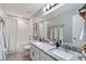 Bathroom with dual sinks and granite countertop at 3425 Middlebrook Pl, Harmony, FL 34773