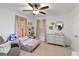 Inviting bedroom with a cozy bed, soft pink accents, and neutral carpeting at 3425 Middlebrook Pl, Harmony, FL 34773