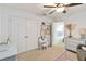 Bright bedroom featuring a ceiling fan, carpeted floors, and access to an adjoining room at 3425 Middlebrook Pl, Harmony, FL 34773