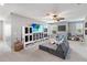 Spacious bonus room with seating, a large TV and plentiful storage at 3425 Middlebrook Pl, Harmony, FL 34773