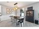 Dining room area showcasing modern lighting and backyard view at 3425 Middlebrook Pl, Harmony, FL 34773