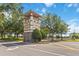 The Harmony community entrance features decorative stone and manicured landscaping at 3425 Middlebrook Pl, Harmony, FL 34773