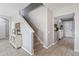 Bright foyer featuring a staircase, decorative console table, and tile flooring at 3425 Middlebrook Pl, Harmony, FL 34773