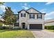 Beautiful two-story home featuring a stone facade, lush lawn and attached two car garage at 3425 Middlebrook Pl, Harmony, FL 34773