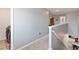 Upstairs hallway features a view of the downstairs kitchen and dining area at 3425 Middlebrook Pl, Harmony, FL 34773