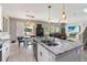 Eat-in kitchen with stainless appliances flows into the dining and living rooms at 3425 Middlebrook Pl, Harmony, FL 34773