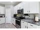 Bright kitchen featuring white cabinets, stainless steel appliances, and modern design at 3425 Middlebrook Pl, Harmony, FL 34773