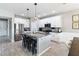 Bright kitchen features stainless appliances, white cabinets, granite counters, a pantry, and an island with seating at 3425 Middlebrook Pl, Harmony, FL 34773