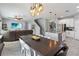 Open kitchen and dining area with granite countertops and stainless steel appliances at 3425 Middlebrook Pl, Harmony, FL 34773