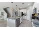 Bright kitchen with granite island, stainless steel appliances, and easy access to stairs at 3425 Middlebrook Pl, Harmony, FL 34773