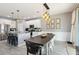Modern kitchen open to dining area with pendant lighting and white cabinetry at 3425 Middlebrook Pl, Harmony, FL 34773
