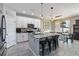 Bright eat-in kitchen features an island with seating, granite counters, stainless appliances and a view to the outside at 3425 Middlebrook Pl, Harmony, FL 34773