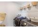 Well-organized laundry room featuring Samsung washer and dryer and stylish storage baskets on mounted shelves at 3425 Middlebrook Pl, Harmony, FL 34773