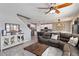 Open-concept living room showcasing a comfortable sofa and view to kitchen at 3425 Middlebrook Pl, Harmony, FL 34773