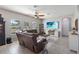 Bright living room with a ceiling fan and sectional sofa, featuring a large television at 3425 Middlebrook Pl, Harmony, FL 34773