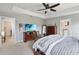 Spacious main bedroom featuring a TV, tray ceiling, hardwood furniture, and an ensuite bathroom at 3425 Middlebrook Pl, Harmony, FL 34773