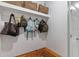The mudroom features a wood bench with space to store shoes and hooks for hanging coats and backpacks at 3425 Middlebrook Pl, Harmony, FL 34773