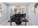 Modern office with built-in shelving, large desk, and natural light at 3425 Middlebrook Pl, Harmony, FL 34773