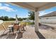 Back patio with a table, chairs, and a clear view of the large, grassy backyard at 3425 Middlebrook Pl, Harmony, FL 34773