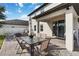 Back patio with dining set and a view of the spacious backyard and neighboring houses at 3425 Middlebrook Pl, Harmony, FL 34773