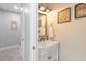 Charming powder room with farmhouse style sink, bronze mirror, and decorative wall art at 3425 Middlebrook Pl, Harmony, FL 34773