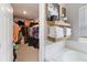 Well-organized walk-in closet and bath featuring storage shelves, drawers, and hanging racks at 3425 Middlebrook Pl, Harmony, FL 34773