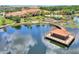 Breathtaking aerial view of the community clubhouse, pool, lake, boardwalk, and lush landscaping at 352 Alicante Ct, Davenport, FL 33837