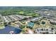 An aerial view of a neighborhood, tennis courts, and a lake on a sunny day at 352 Alicante Ct, Davenport, FL 33837