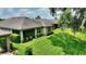 Large backyard with a well-maintained lawn, mature trees, and a covered patio, perfect for outdoor living at 352 Alicante Ct, Davenport, FL 33837