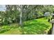 Lush backyard featuring mature trees and well-maintained green lawn, providing a serene outdoor environment at 352 Alicante Ct, Davenport, FL 33837