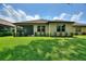 Well-maintained backyard showcasing a screened-in lanai, verdant lawn, and neat shrubbery along the home's exterior at 352 Alicante Ct, Davenport, FL 33837