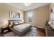 Simple bedroom featuring neutral walls, hardwood floors, and a window overlooking greenery at 352 Alicante Ct, Davenport, FL 33837