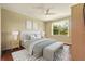 Cozy bedroom with a large window, light-colored walls, and a comfortable bed with stylish linens at 352 Alicante Ct, Davenport, FL 33837