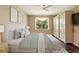 Cozy bedroom with neutral walls, a large window, and an ensuite bathroom at 352 Alicante Ct, Davenport, FL 33837