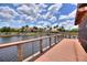 Picturesque boardwalk alongside a lake with manicured landscaping, connecting to nearby community buildings at 352 Alicante Ct, Davenport, FL 33837