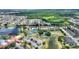 Aerial view of the community showcasing the club house, tennis courts, lakes, landscaping, and homes at 352 Alicante Ct, Davenport, FL 33837