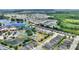 Aerial view of the community showcasing the club house, tennis courts, lakes, landscaping, and homes at 352 Alicante Ct, Davenport, FL 33837