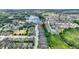 Aerial view of the community showcasing the club house, tennis courts, lakes, landscaping, and homes at 352 Alicante Ct, Davenport, FL 33837