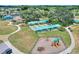 Aerial view of a community park, showcasing bocce ball, a playground, and landscaping at 352 Alicante Ct, Davenport, FL 33837